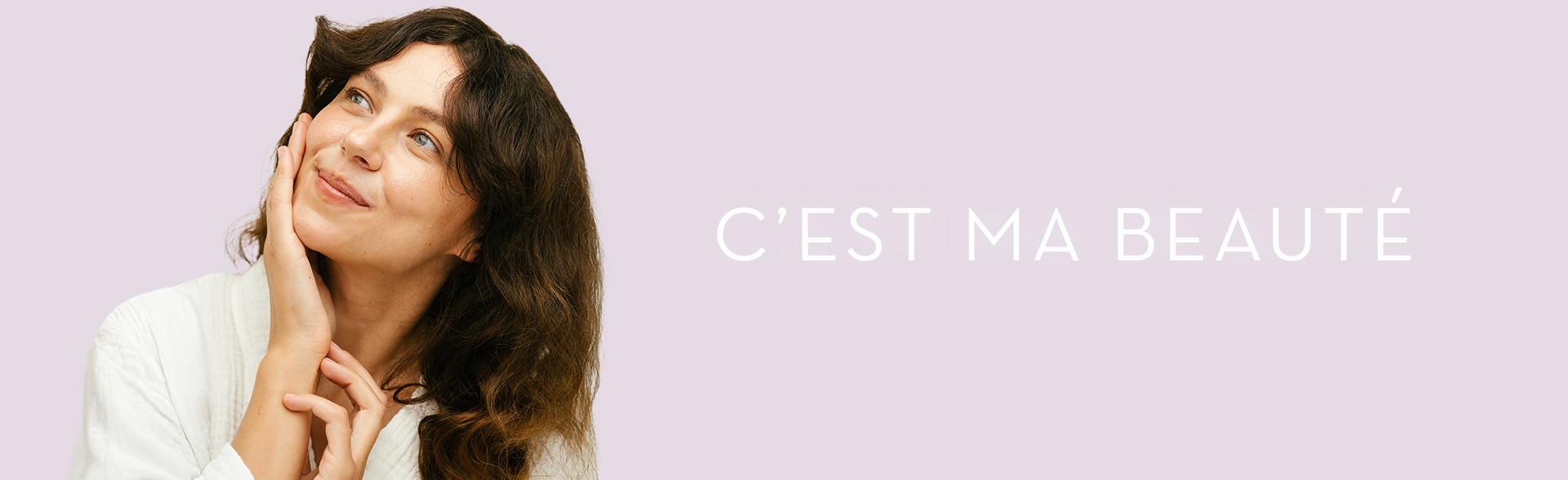 Eine Frau mit roter Schleife im Haar steht mit dem Rücken zur Kamera nah am Eifelturm.