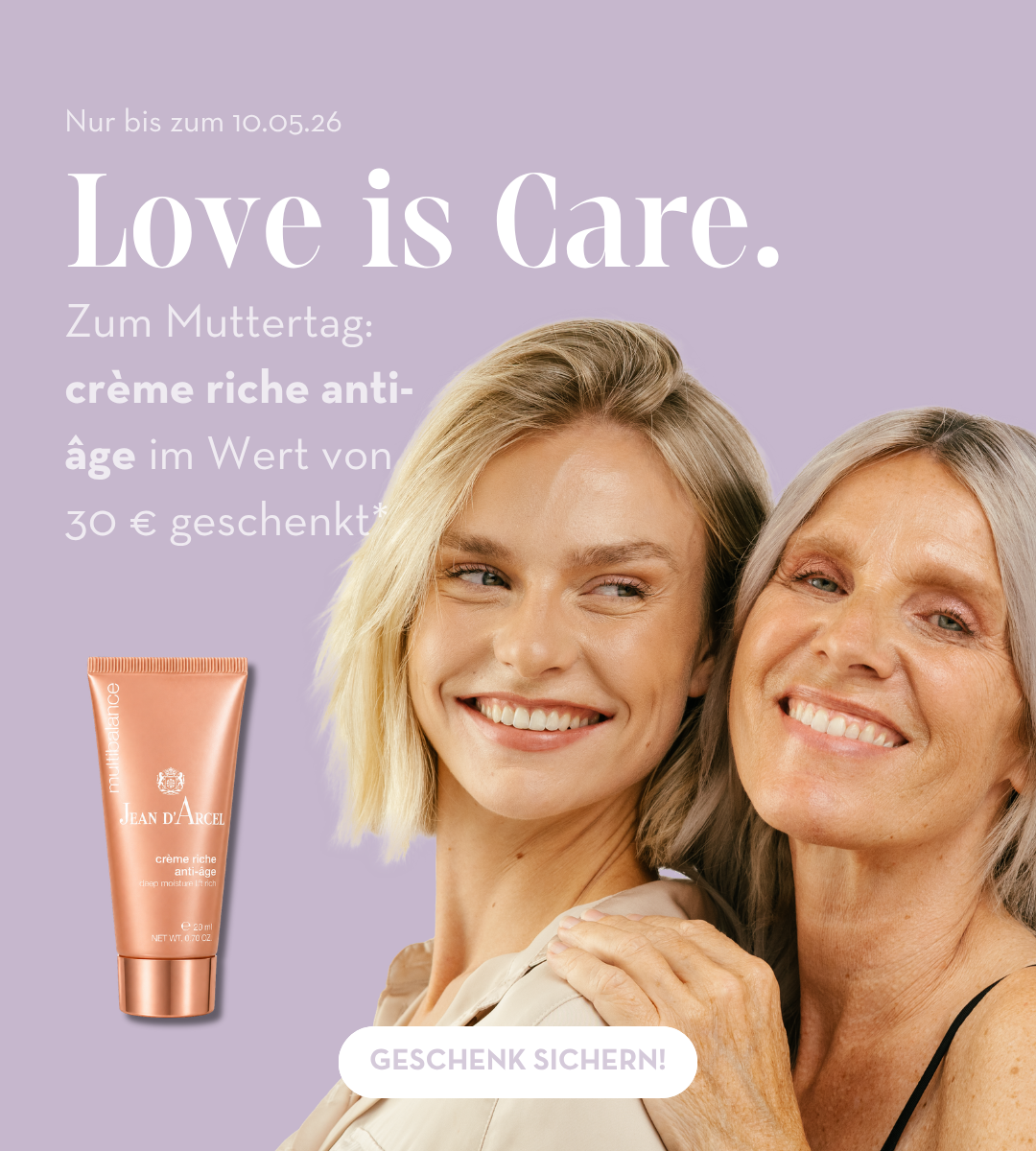 Werbebanner in sanftem Lila: Zwei lächelnde Frauen (eine jüngere und eine ältere) stehen eng beieinander und vermitteln Nähe und Fürsorge. Daneben ist eine Tube „crème riche anti-âge“ von Jean d’Arcel abgebildet. Text: „Love is Care. Zum Muttertag: crème riche anti-âge im Wert von 30 € geschenkt. Nur bis zum 10.05.26.“ Button: „Geschenk sichern!“